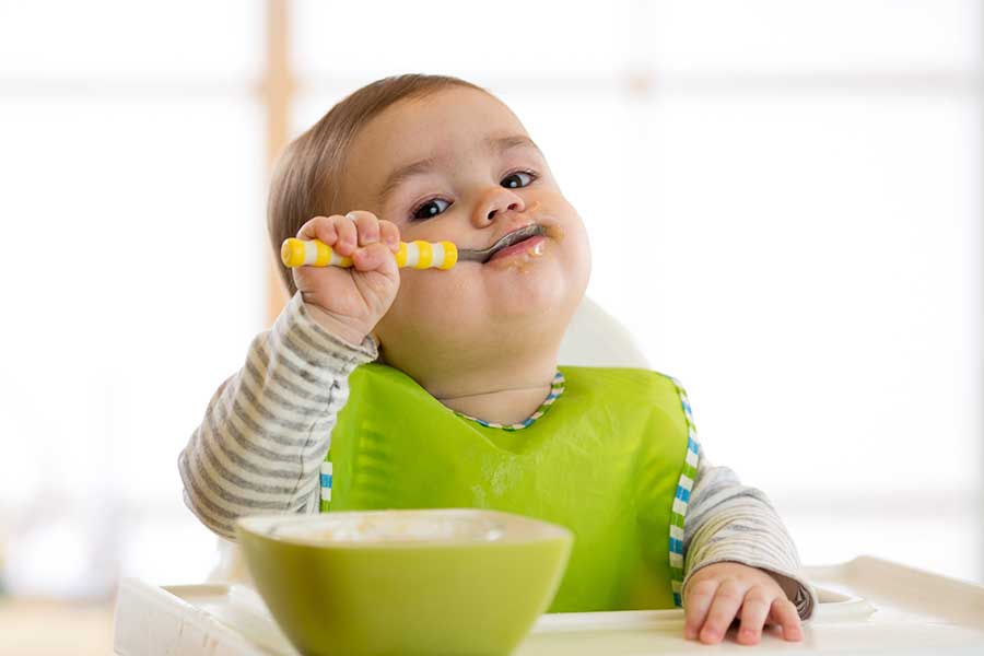 baby in a high chair eating
