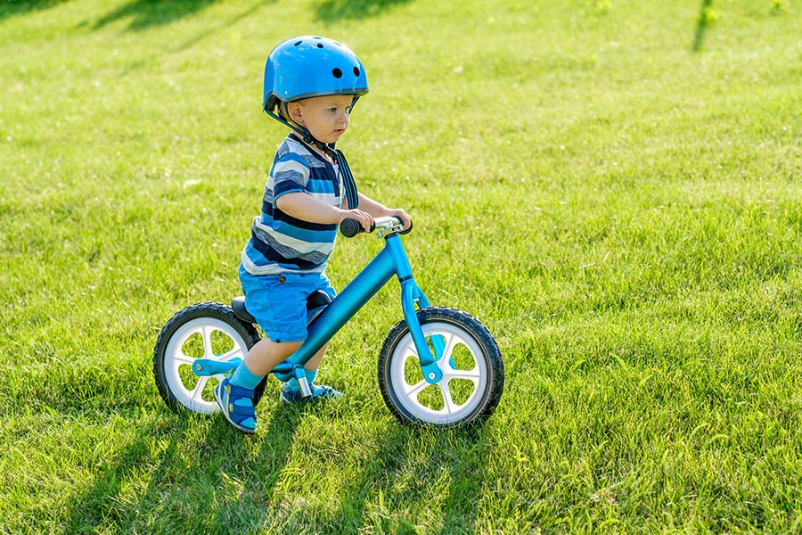 child wearing safety helmet while riding bicycle
