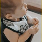 Baby wearing bib looking up